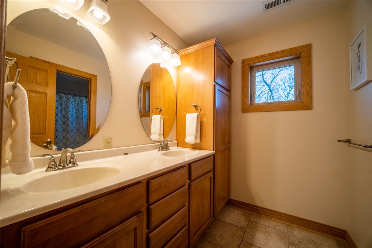 2685 Rogene Drive Oregon, IL 61061 - Photo 25 of 40 a bathroom with a double vanity sink and a mirror