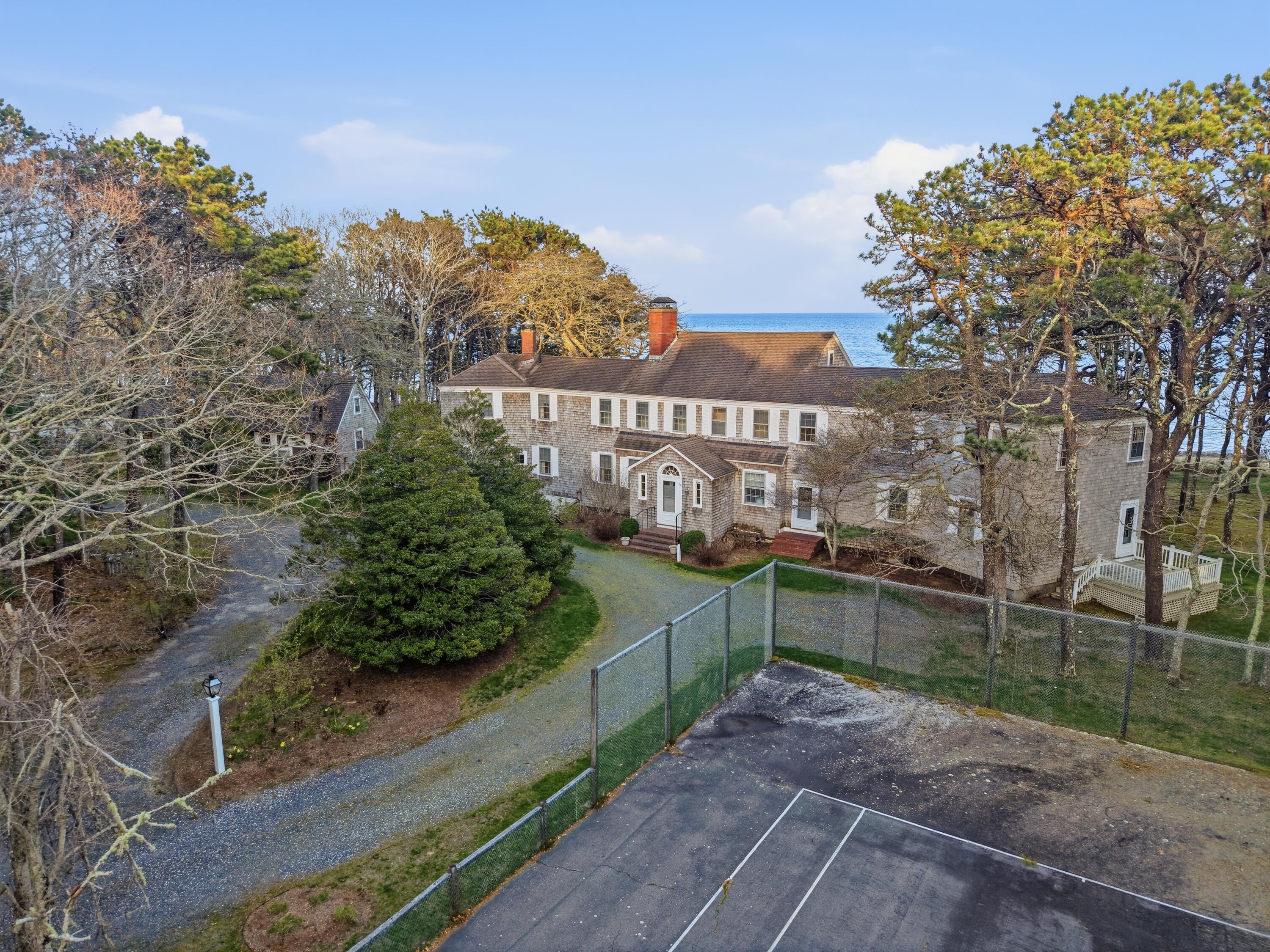 190 Vineyard Road Cotuit, MA 02635 - Photo 3 of 41 a view of a pathway with a wrought fence
