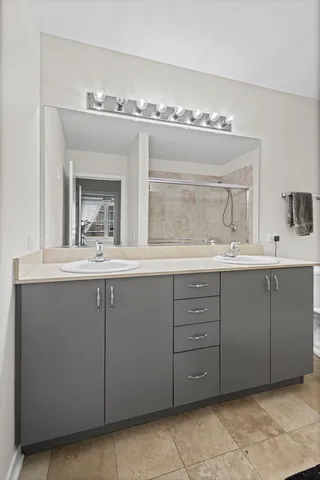 a bathroom with a double vanity sink and a mirror