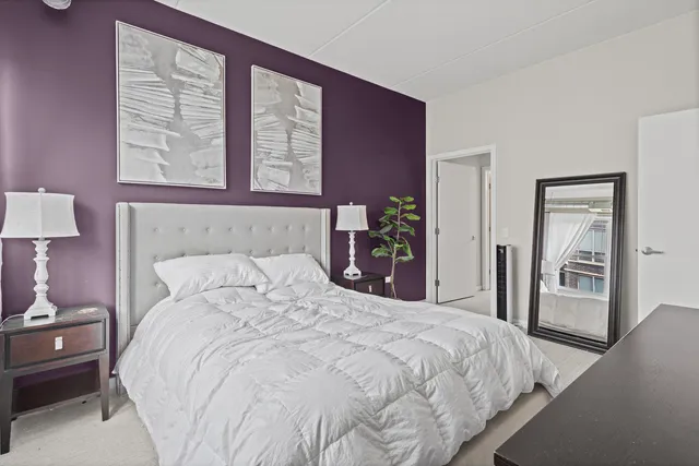 a bedroom with a bed and a night stand