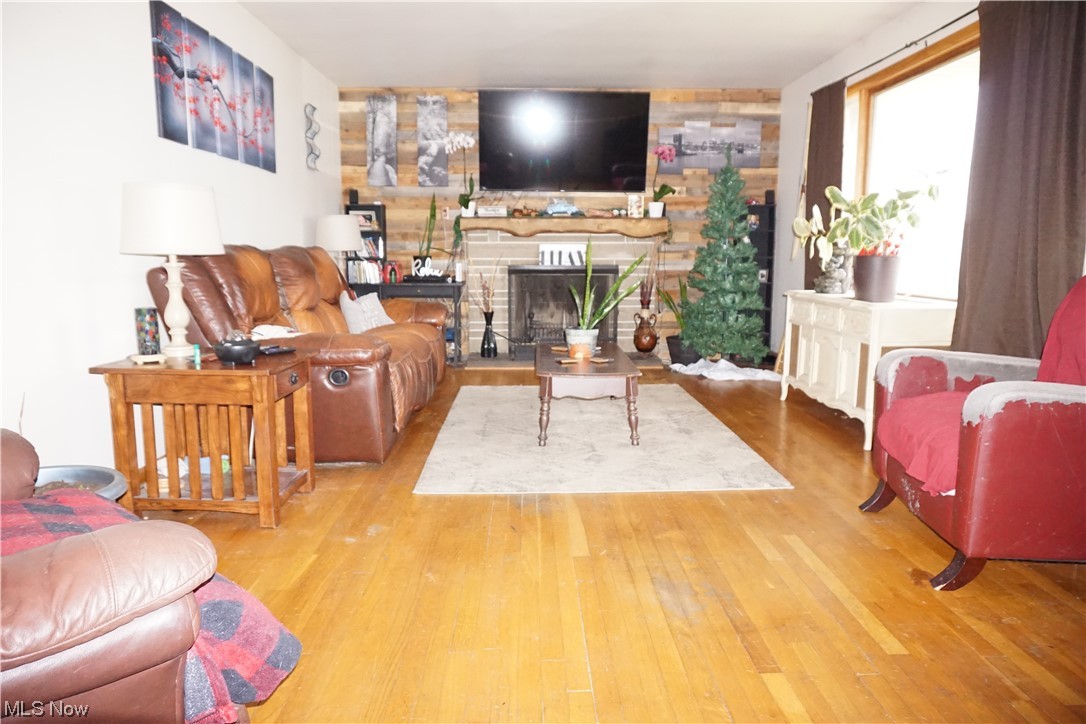 4611 8th Street Northwest Canton, OH 44708 - Photo 2 of 29 Living room with light wood-type flooring and a stone fireplace