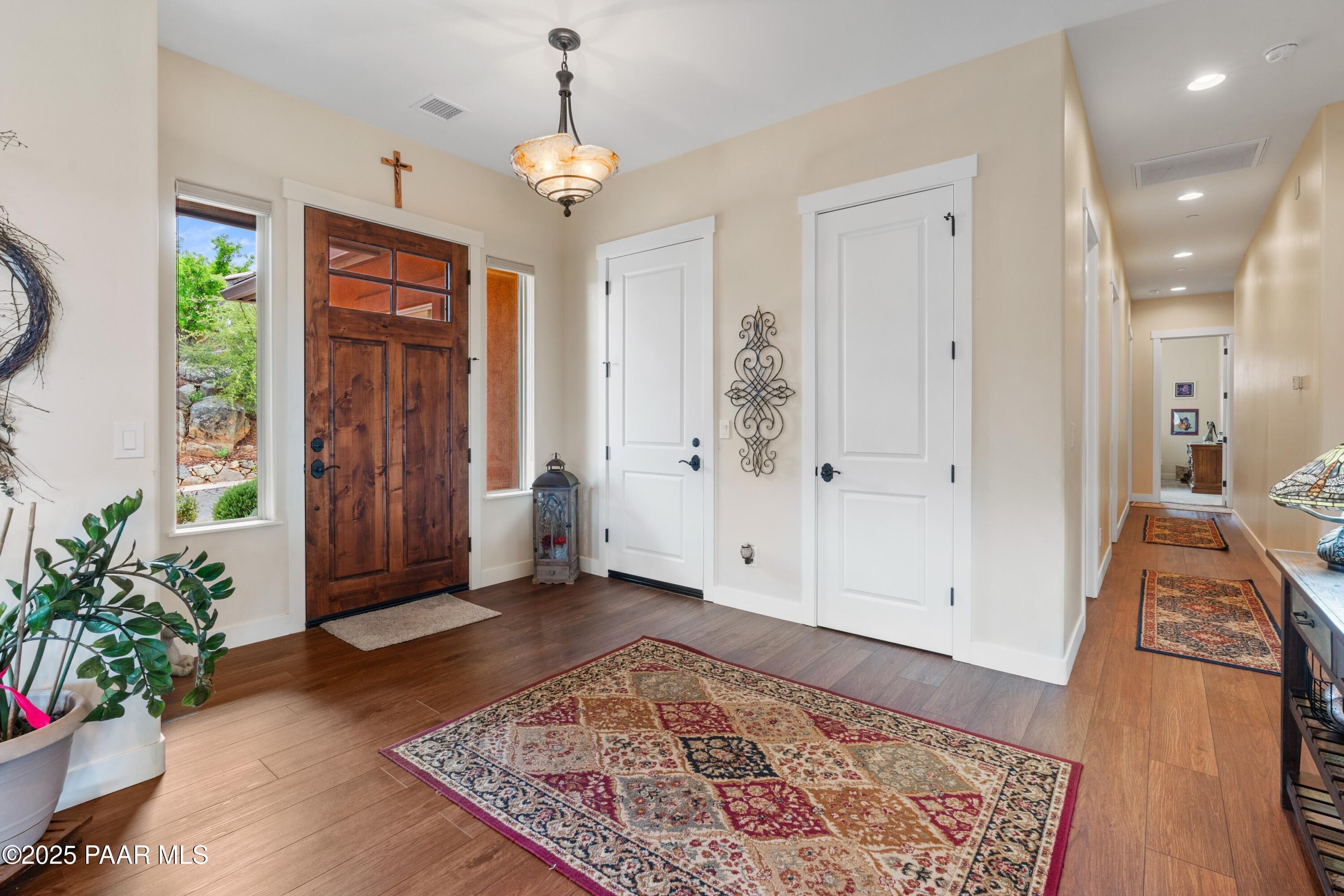 1468 Butte Road Prescott, AZ 86303 - Photo 15 of 31 wooden floor with windows and chandelier