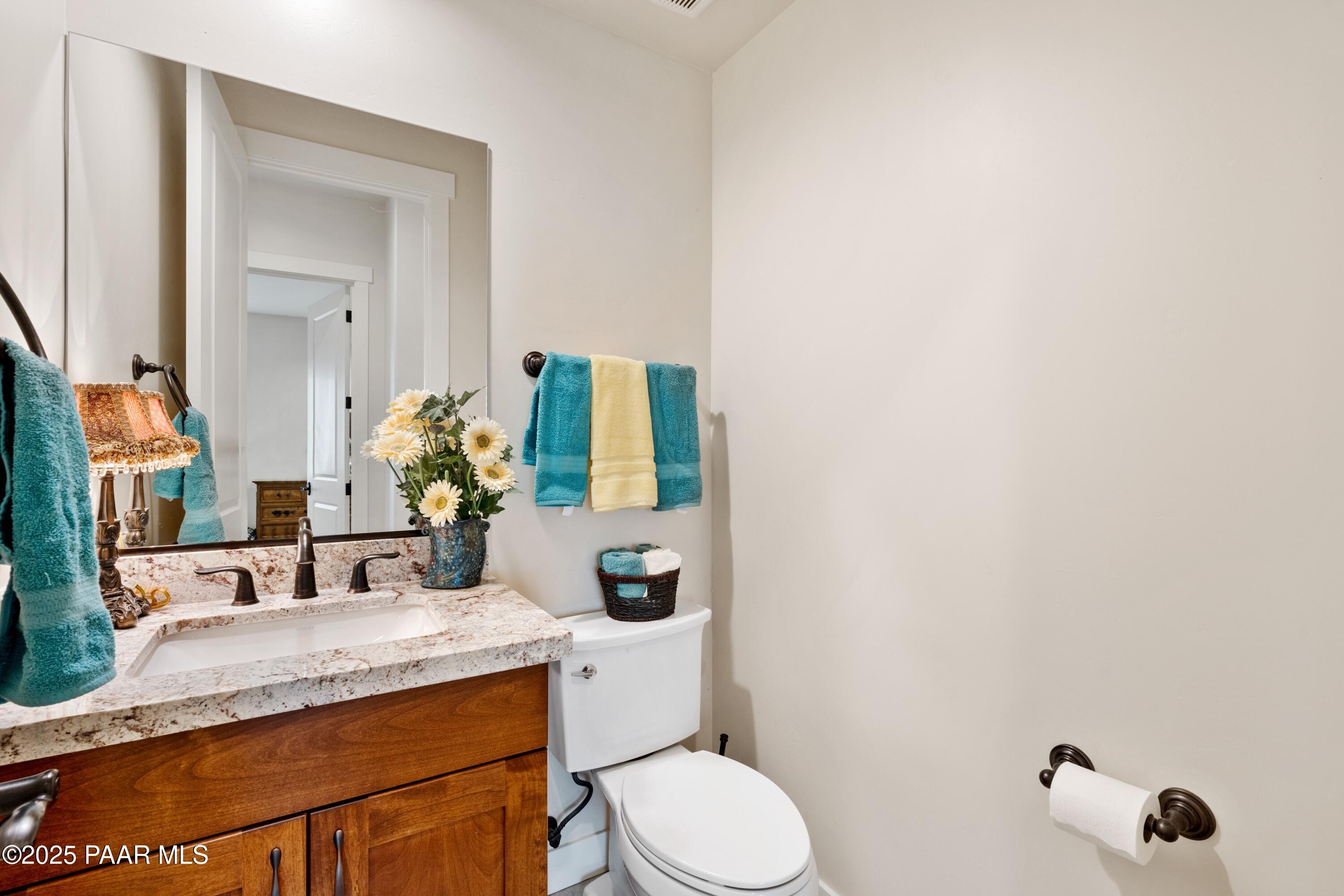 1468 Butte Road Prescott, AZ 86303 - Photo 16 of 31 a bathroom with a granite countertop sink mirror vanity and toilet