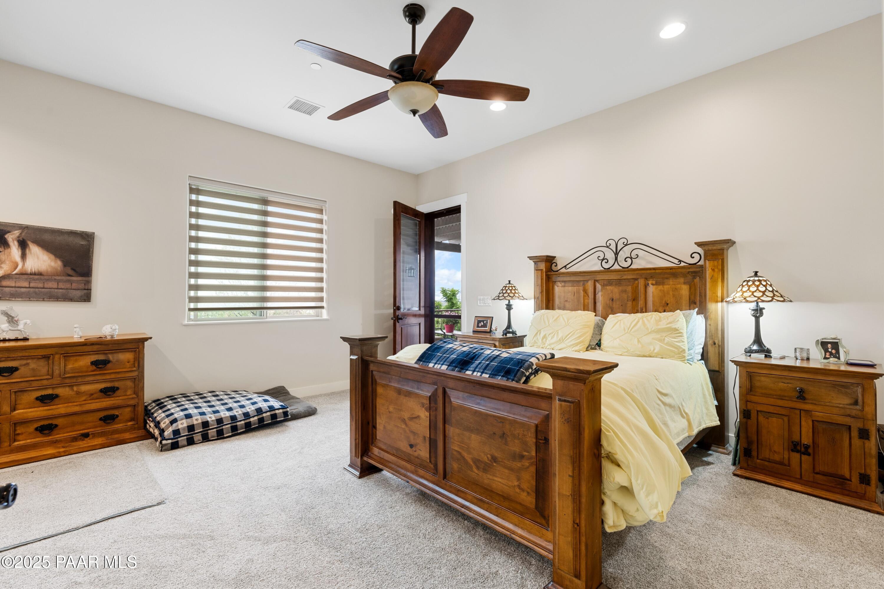 1468 Butte Road Prescott, AZ 86303 - Photo 17 of 31 a bedroom with a bed and a chandelier