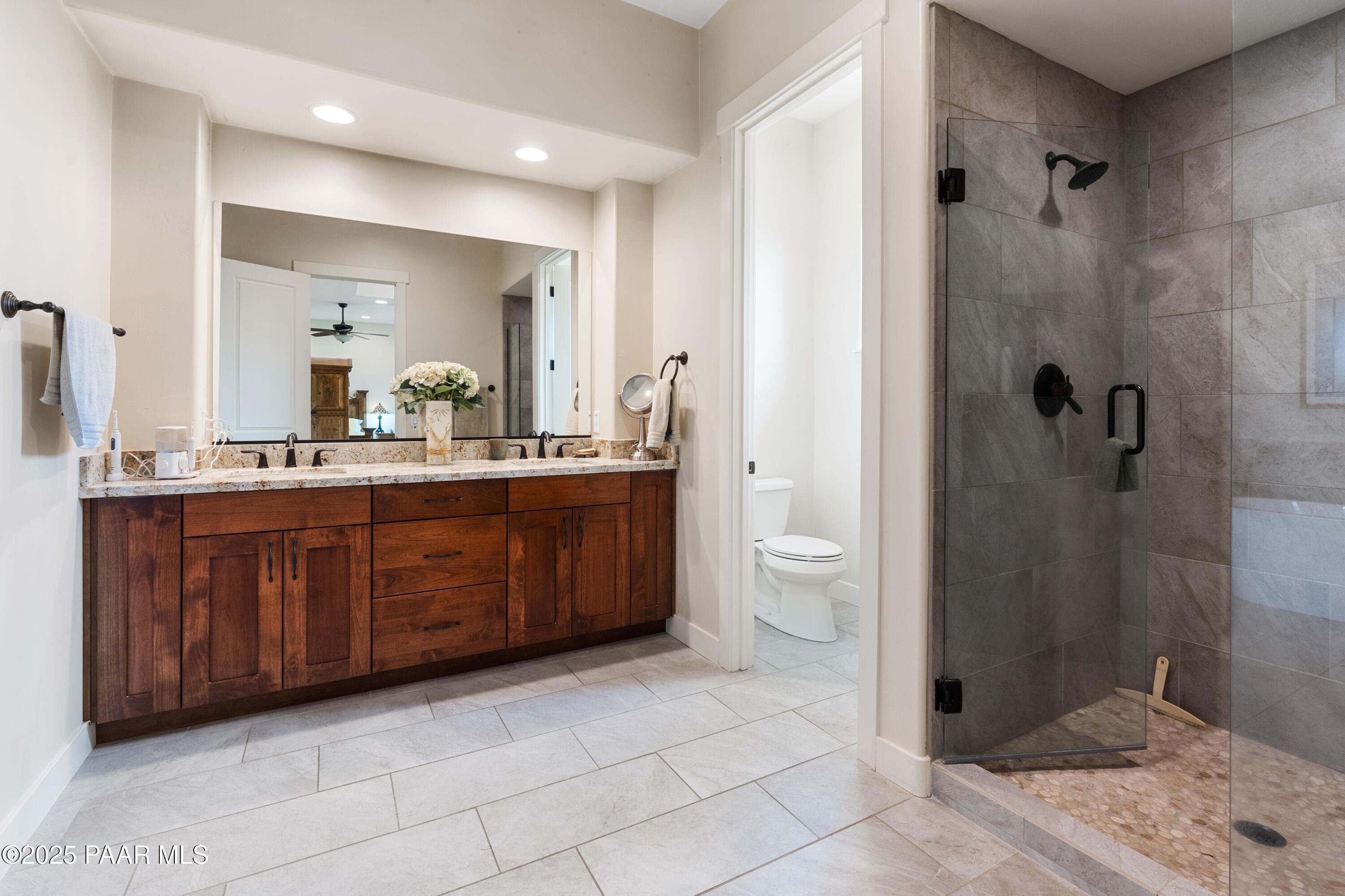 1468 Butte Road Prescott, AZ 86303 - Photo 19 of 31 a bathroom with a double vanity sink toilet and shower