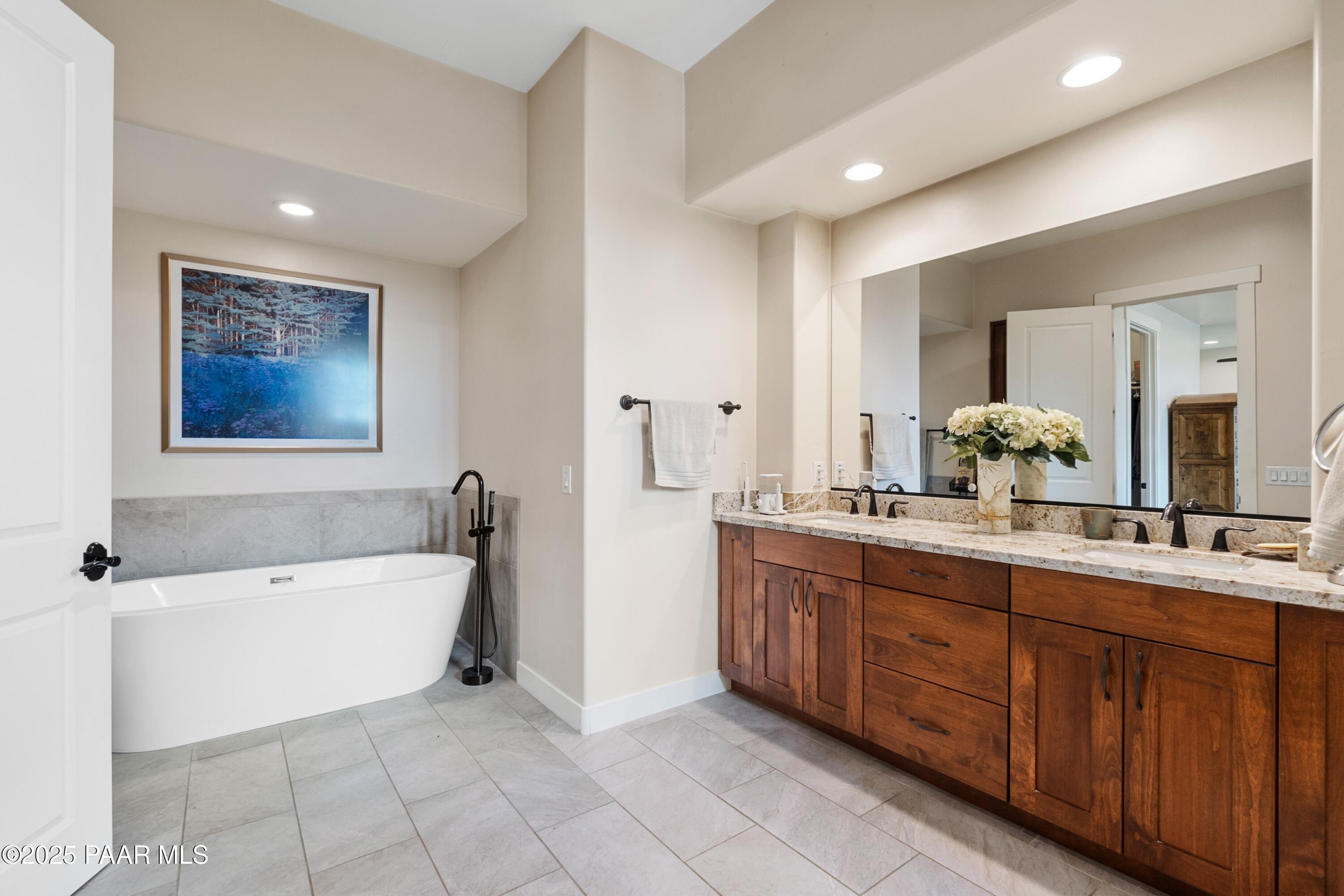 1468 Butte Road Prescott, AZ 86303 - Photo 20 of 31 a spacious bathroom with a double vanity sink a mirror a bathtub and next to a window