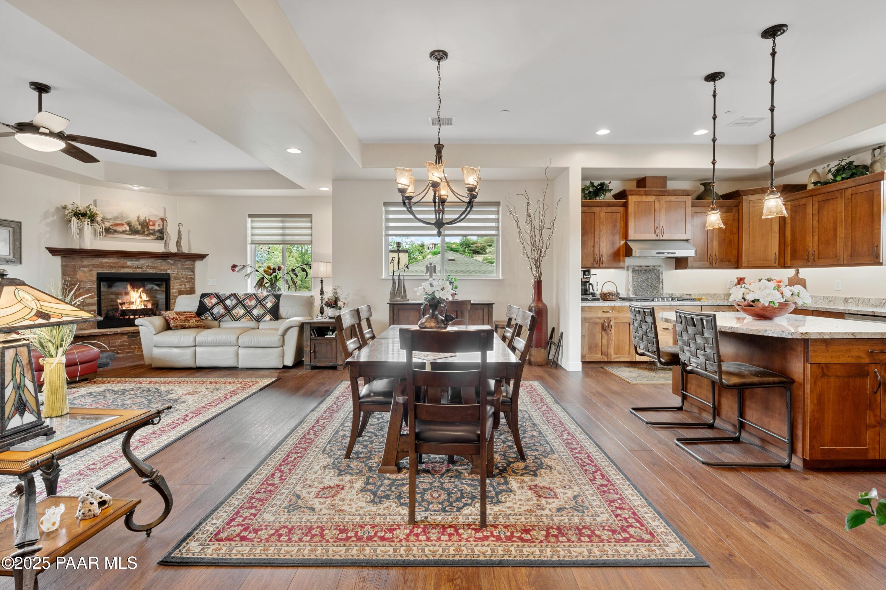 1468 Butte Road Prescott, AZ 86303 - Photo 8 of 31 a living room with dining table furniture kitchen view and a chandelier