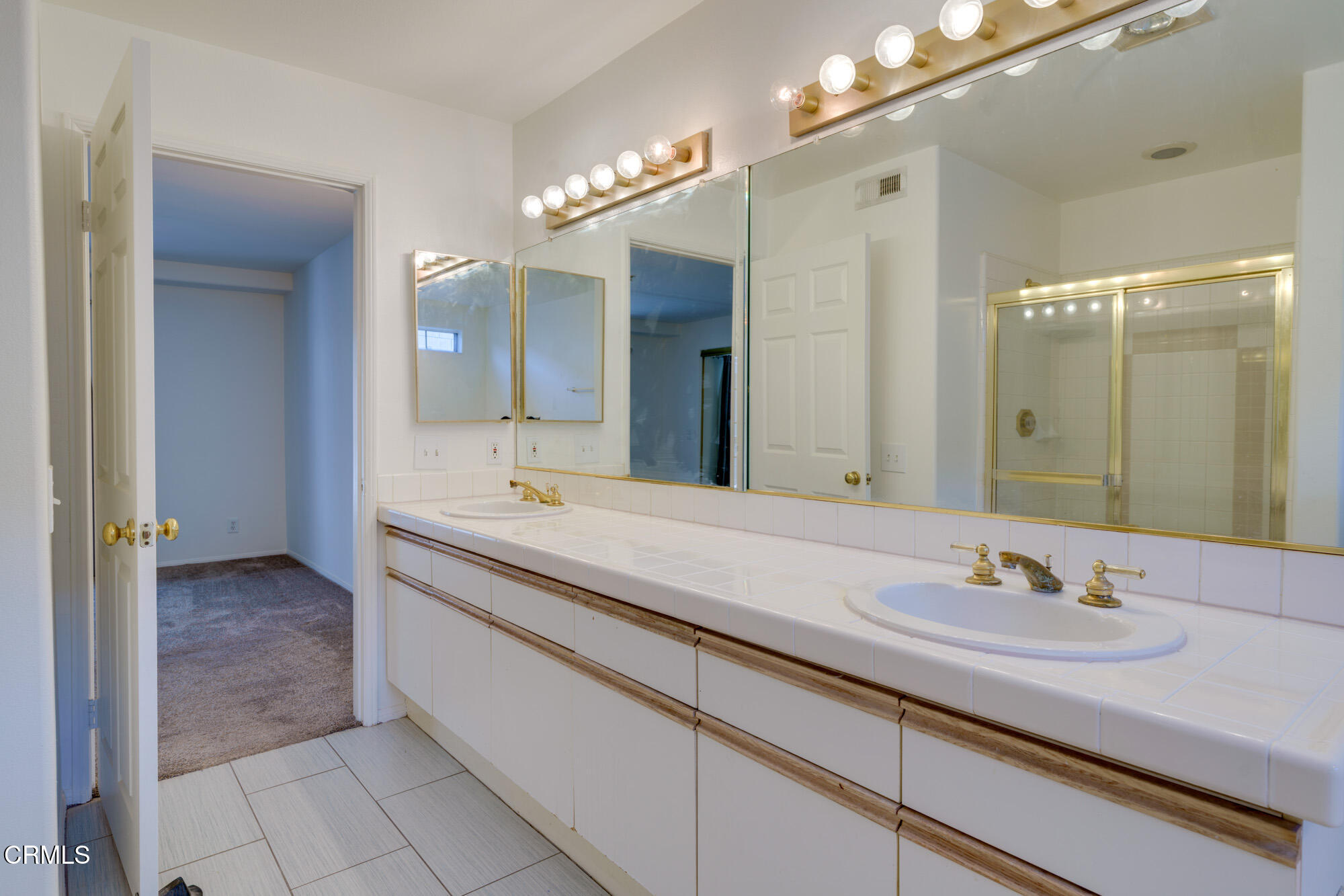 10925 Blix Street, Unit 102 Toluca Lake, CA 91602 - Photo 16 of 29 a bathroom with a sink double vanity and a mirror