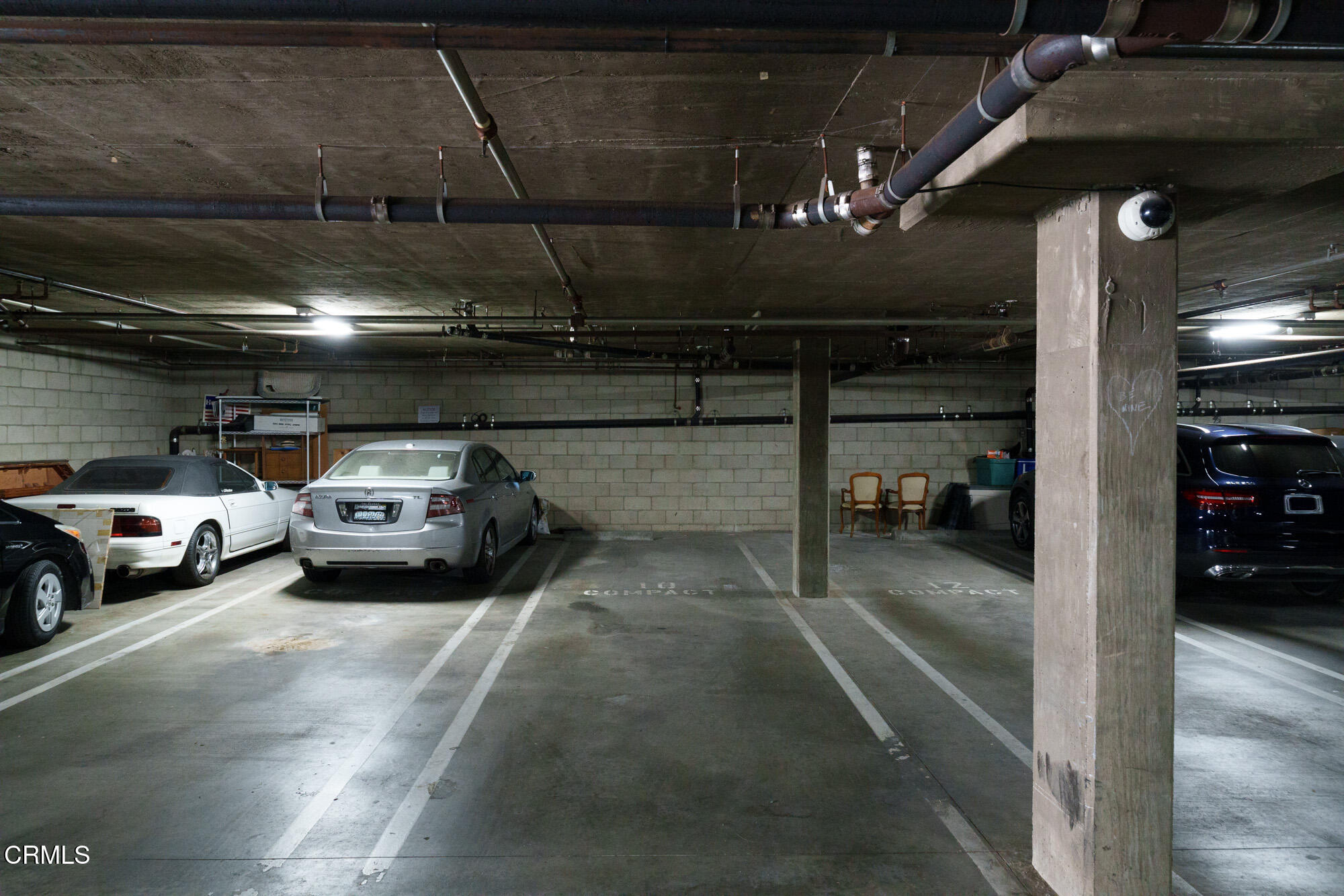 10925 Blix Street, Unit 102 Toluca Lake, CA 91602 - Photo 27 of 29 a view of parking garage with cars parked
