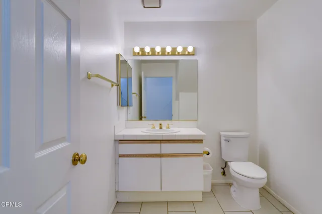a bathroom with a sink a toilet and mirror