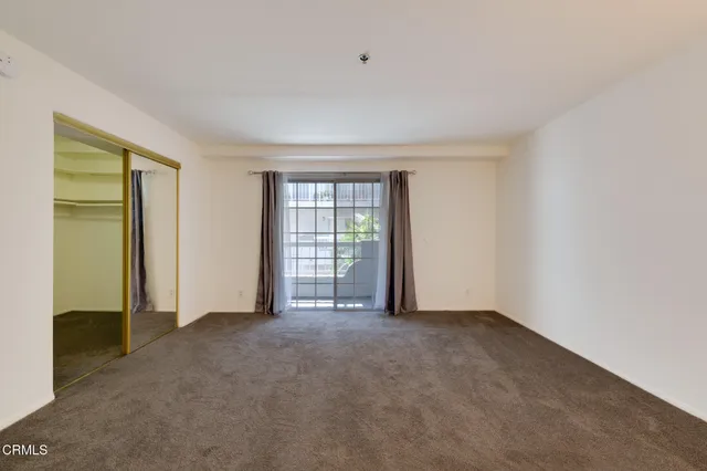 a view of an empty room with closet