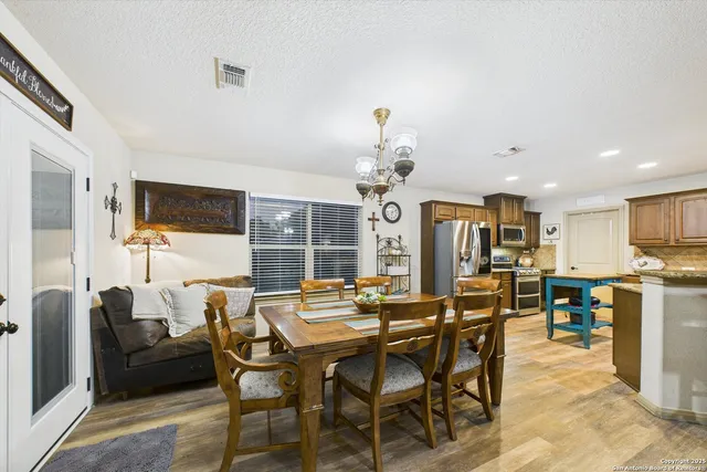 a view of a dining room with furniture and a kitchen