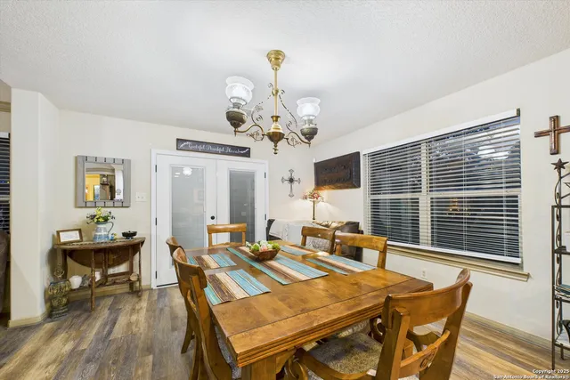 a view of a dining room with furniture wooden floor and chandelier