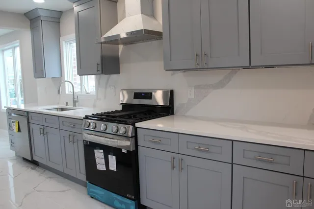 a kitchen with cabinets appliances and a sink