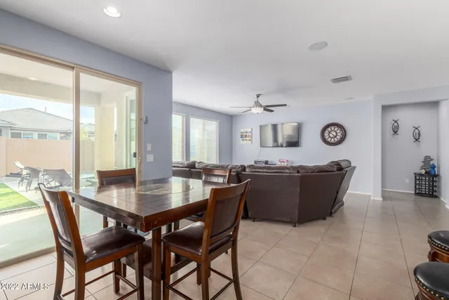 a dining room with a wooden table and chairs