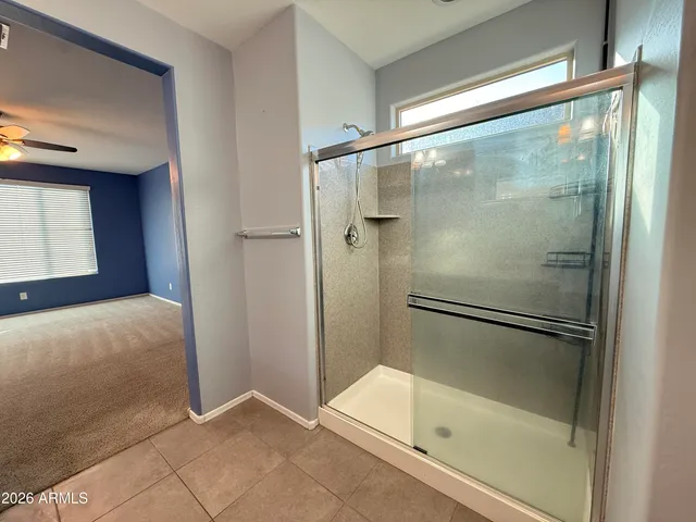 a bathroom with a glass shower door