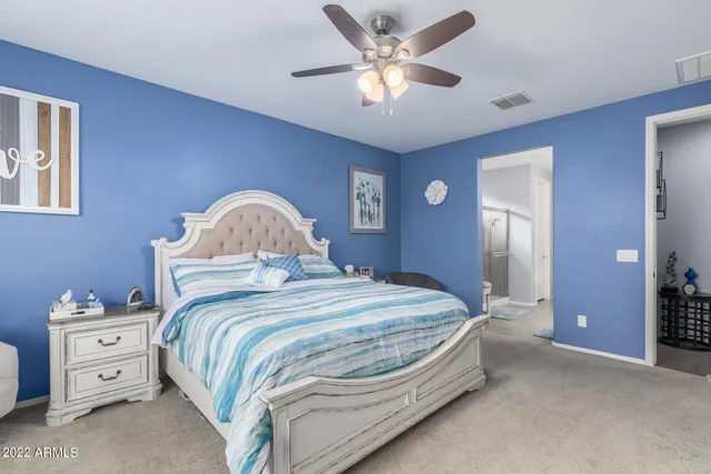 a bedroom with a bed and a chandelier