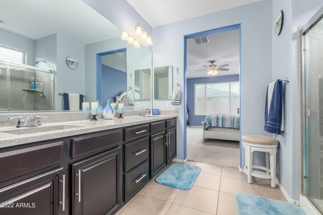 a en suite bathroom with a double vanity sink and a mirror