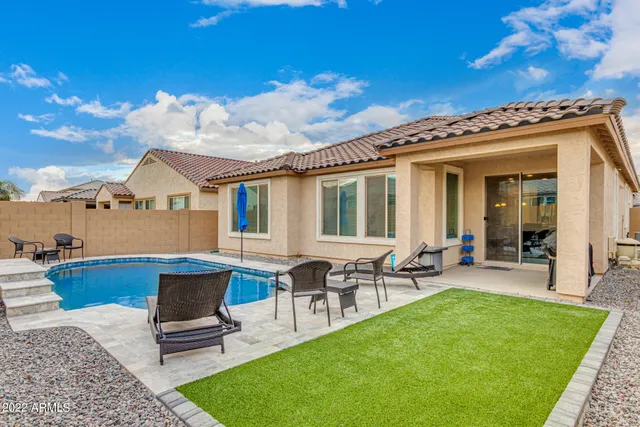 a view of a house with patio and a yard