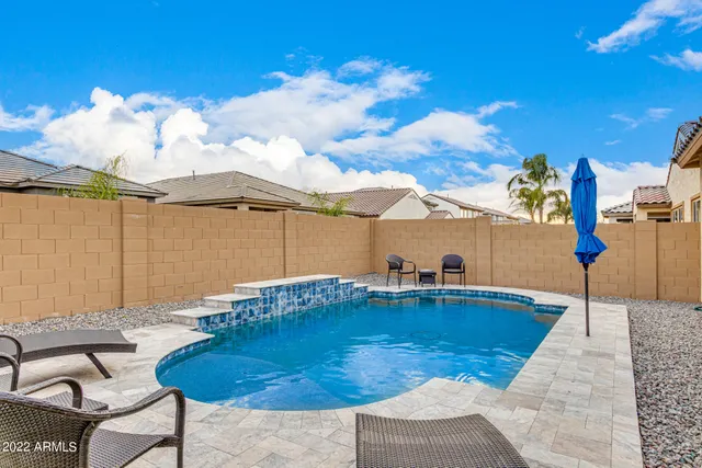 swimming pool view with a seating space