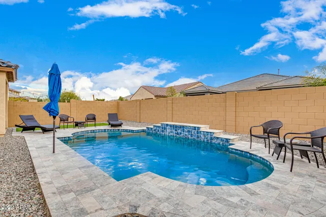 a view of a swimming pool with a table and chairs