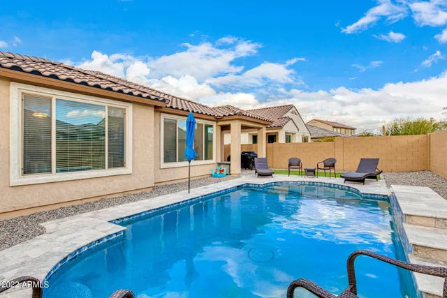 a view of a patio with swimming pool table and chairs