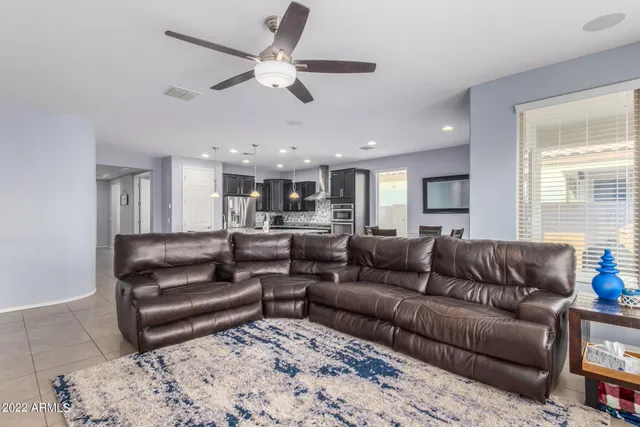 a living room with furniture and kitchen view