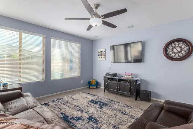 a bedroom with furniture and a large window