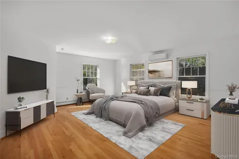 a bedroom with a bed and flat screen tv