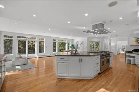 a large kitchen with stainless steel appliances granite countertop a lot of counter space and wooden floor