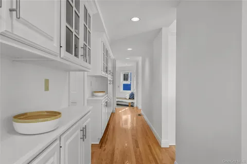 a view of a bathroom with a sink and a wooden floor