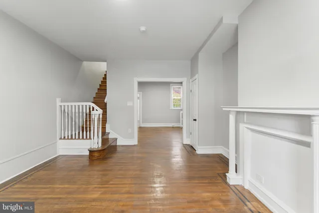 a view of a room with wooden floor and chair