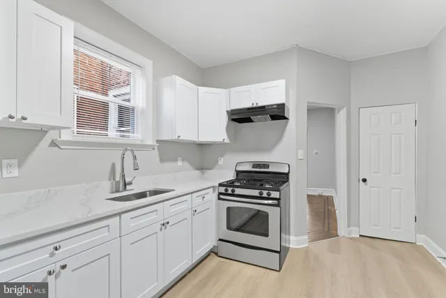 a kitchen with cabinets appliances and a window