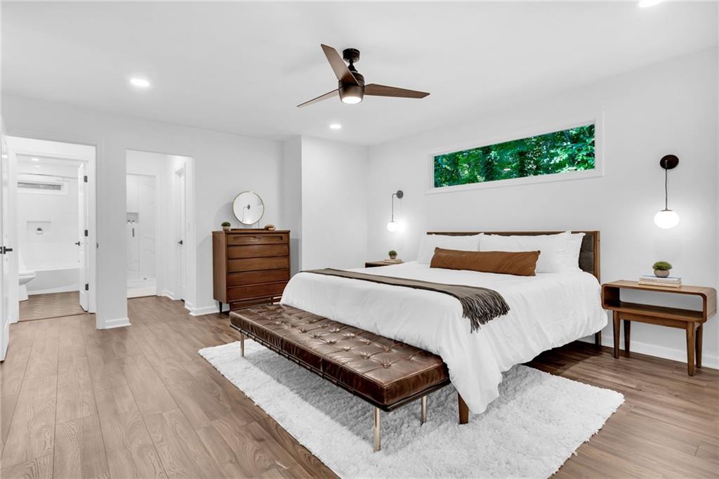 3882 The Ascent Northeast Atlanta, GA 30319 - Photo 18 of 56 a spacious bedroom with a bed and a chandelier
