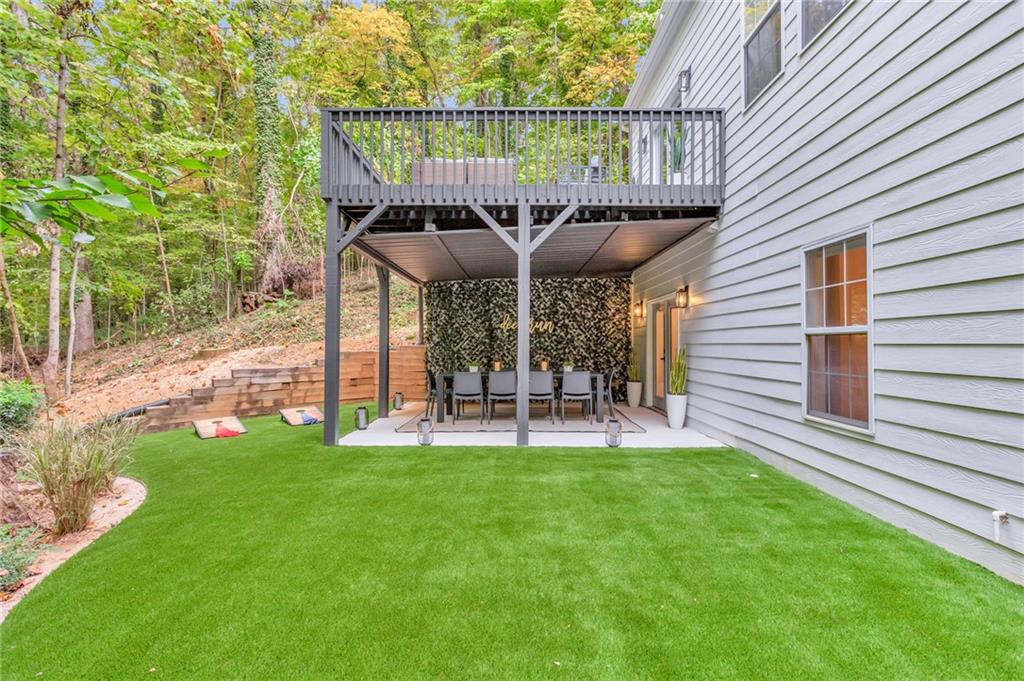 3882 The Ascent Northeast Atlanta, GA 30319 - Photo 53 of 56 a view of a chair and table in backyard of the house