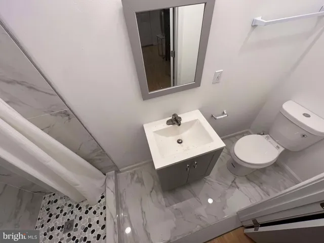 a white toilet sitting next to a bathroom sink