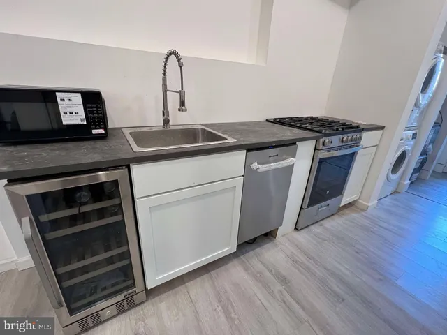 a kitchen with granite countertop a stove and a sink