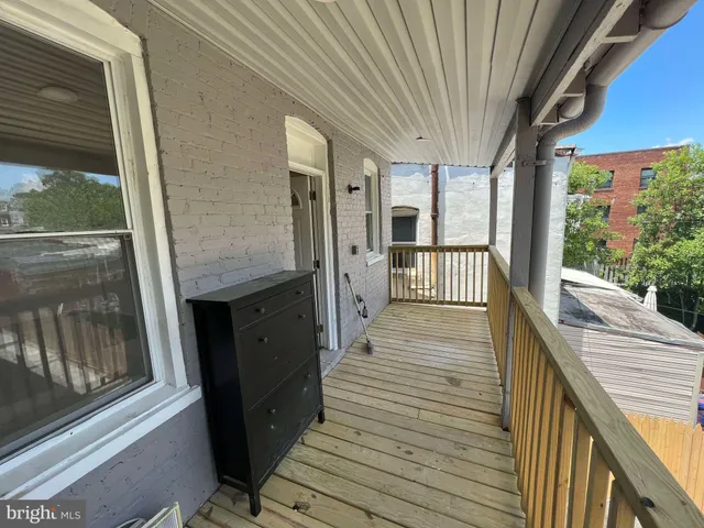 a view of a house with wooden deck