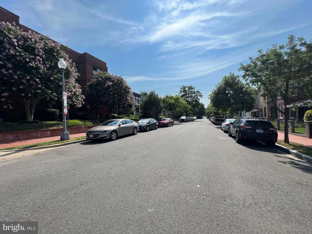 a view of street with parked cars