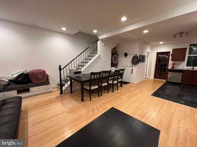 a living room with furniture a wooden floor and next to a window