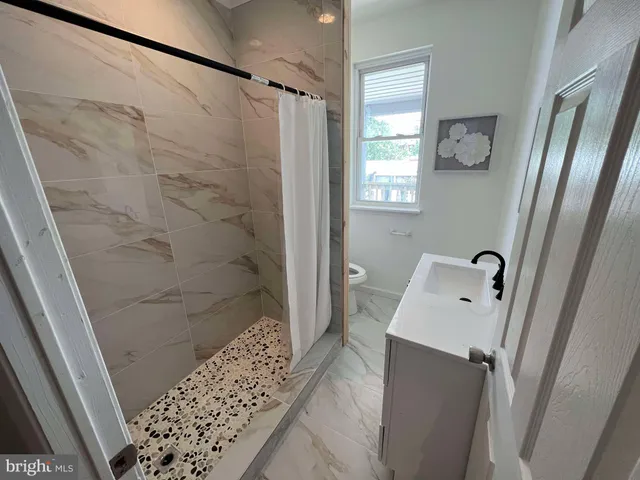 a bathroom with a shower and a sink