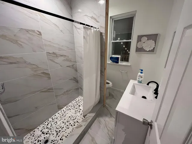 a bathroom with a bathtub and shower