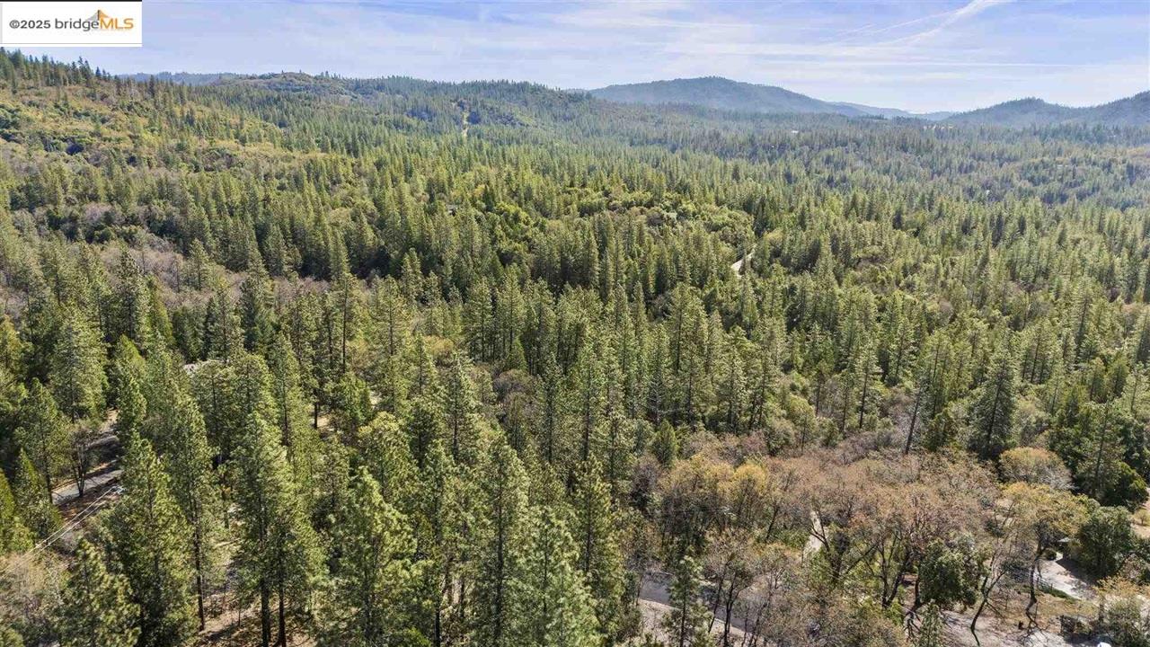 23282 Comstock Ranch Road Sonora, CA 95370 - Photo 10 of 19 a view of a lush green hillside and a mountain