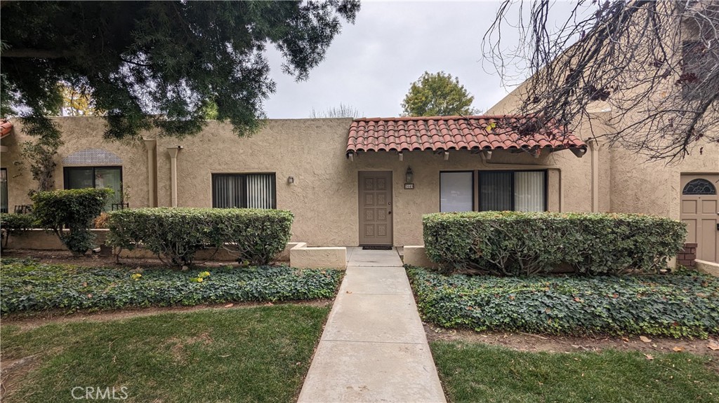 a front view of a house with a garden