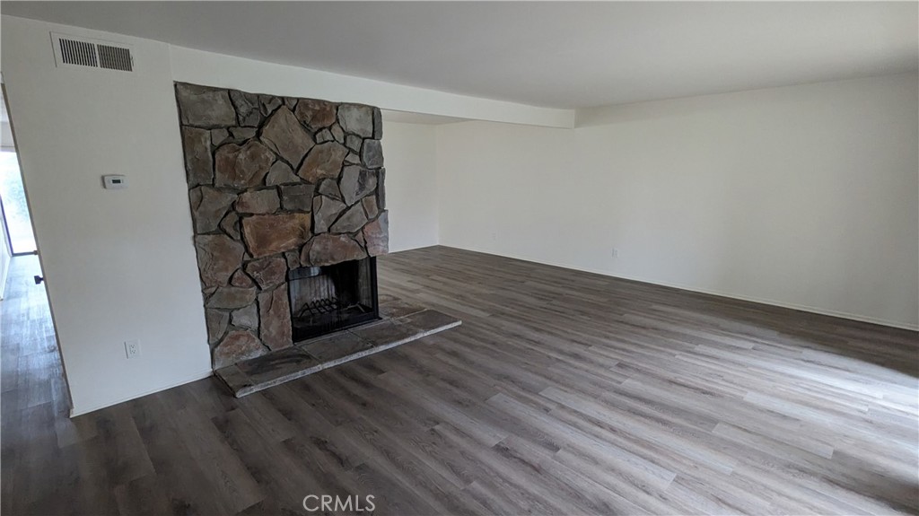2645 Cortina Drive Riverside, CA 92506 - Photo 2 of 17 a view of a hallway with wooden floor and a fireplace