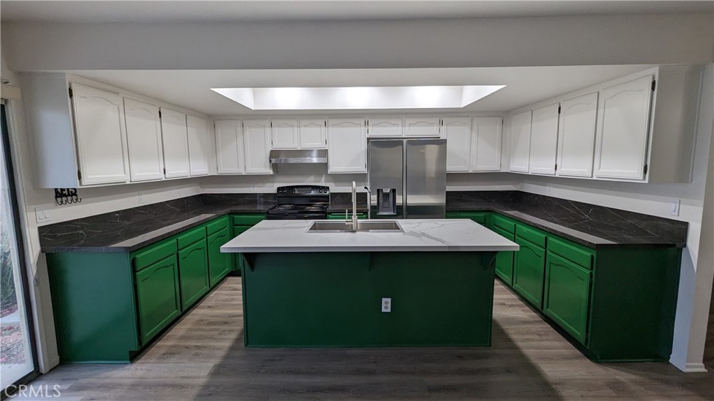 2645 Cortina Drive Riverside, CA 92506 - Photo 6 of 17 a kitchen with kitchen island stainless steel appliances granite countertop a sink and cabinets