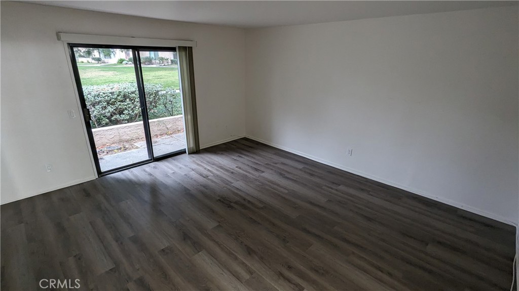 2645 Cortina Drive Riverside, CA 92506 - Photo 9 of 17 a view of an empty room with wooden floor and a window