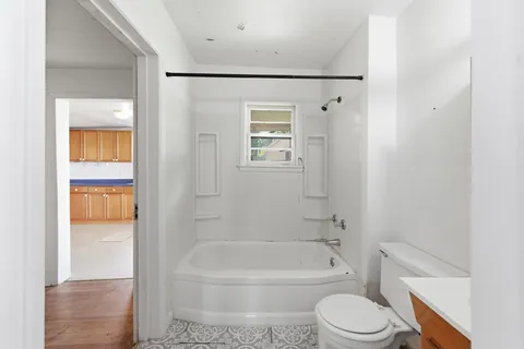 a bathroom with a toilet and a bathtub