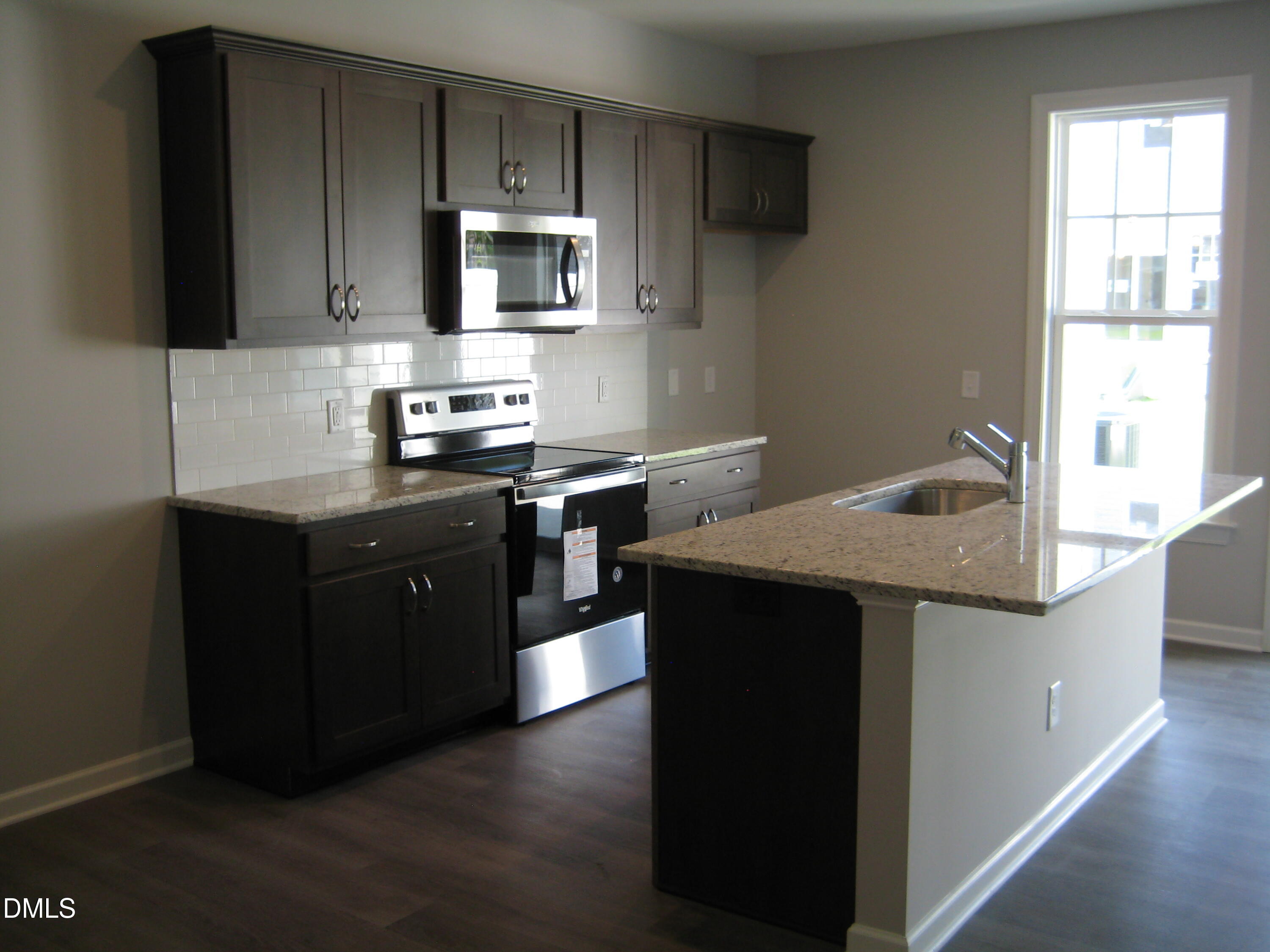 422 Morgan Brook Way Rolesville, NC 27571 - Photo 4 of 6 a kitchen with a sink stove and microwave