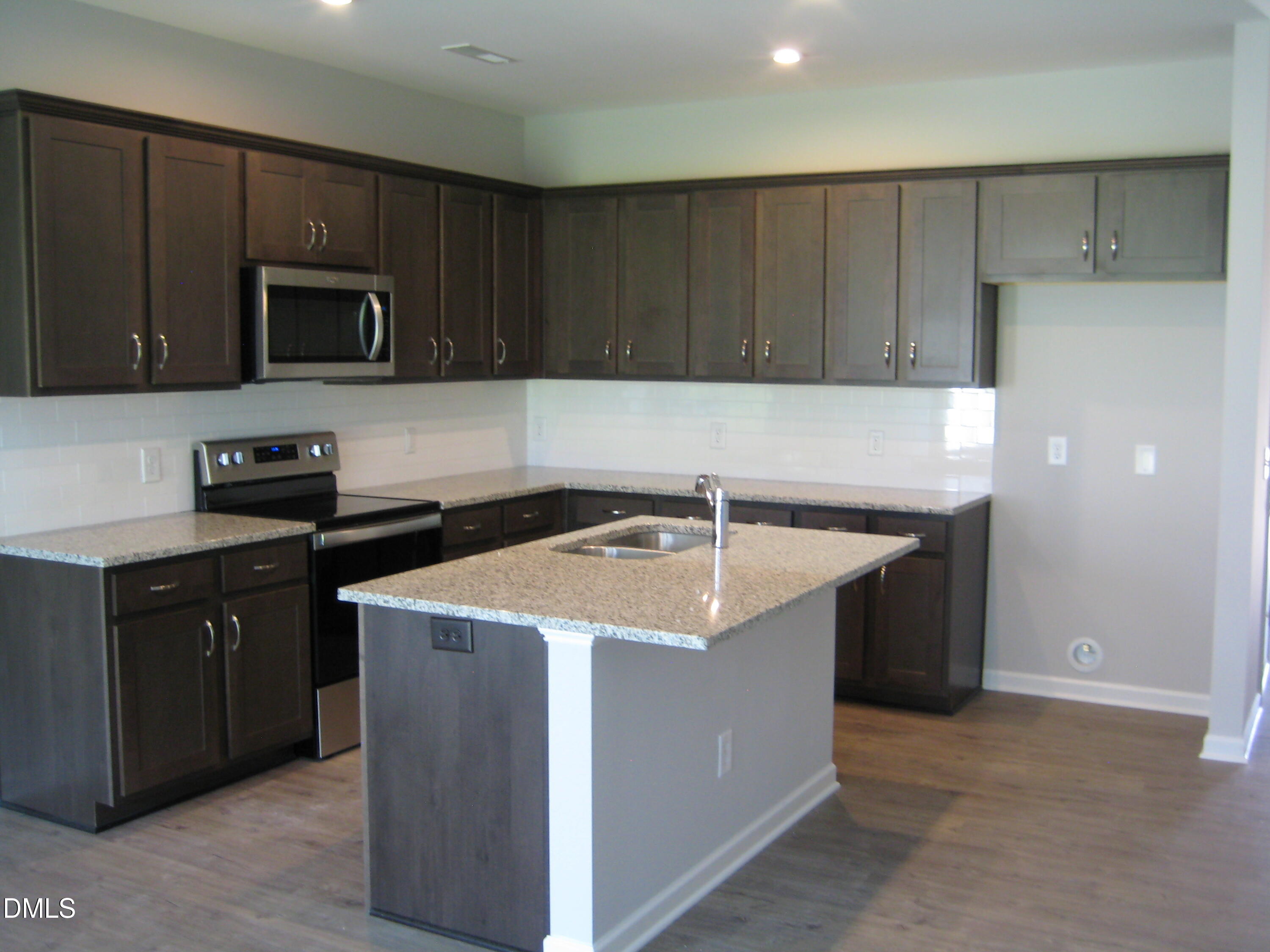 422 Morgan Brook Way Rolesville, NC 27571 - Photo 5 of 6 a kitchen that has a sink and a stove in it